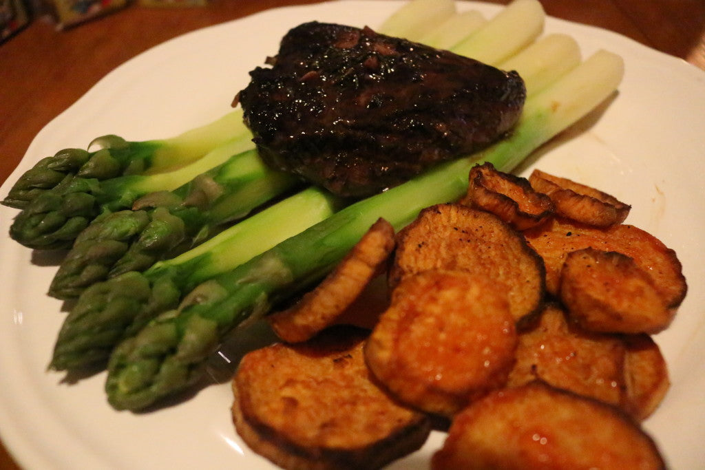 Juicy steak with a rich red wine sauce, crispy sweet potato and fresh green asparagus