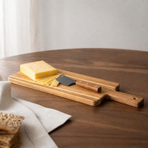 Acacia kaasplank met jonge kaas, plakjes en kaasmes naast crackers