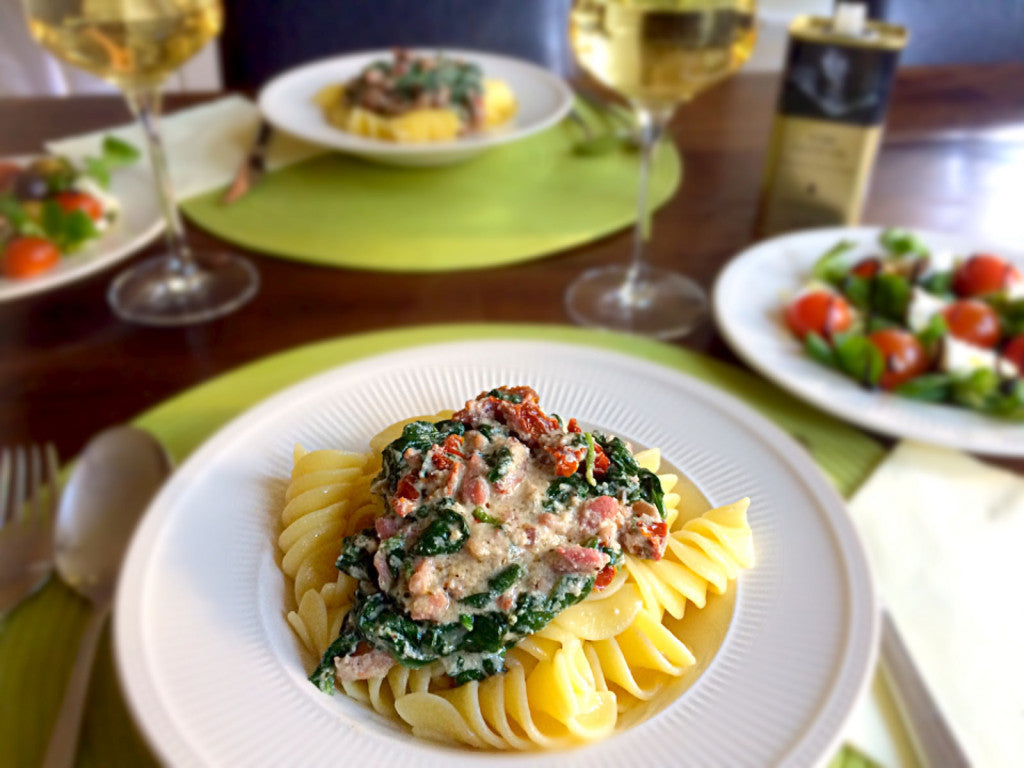 A creamy pasta dish with spinach, ricotta and crispy bacon
