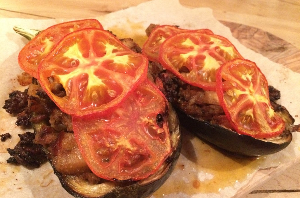 A flavorful stuffed aubergine dish with spiced ground beef and fresh tomato