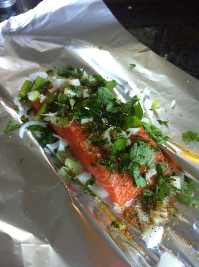 Juicy BBQ salmon fillet with fresh herbs and lemon
