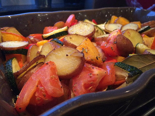 A colorful oven dish full of autumn vegetables