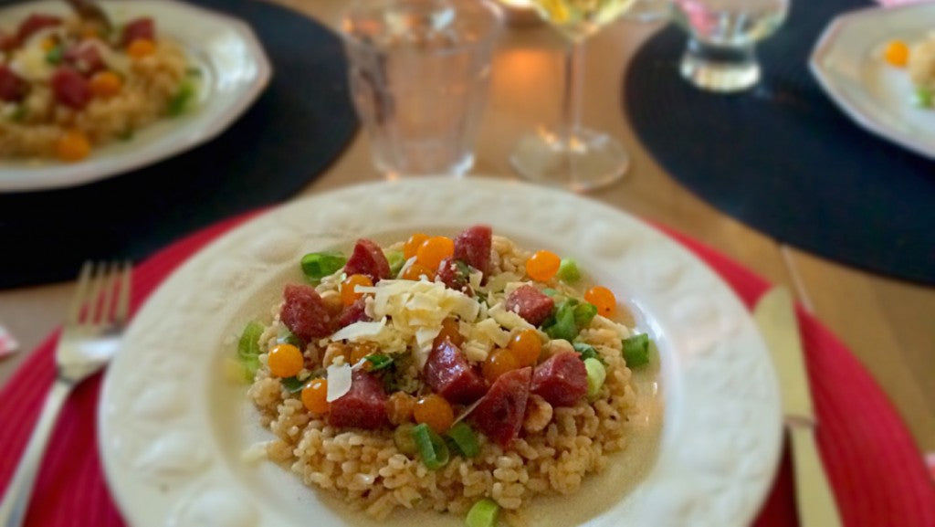 Creamy risotto with truffle sausage, hazelnuts and cherry tomatoes