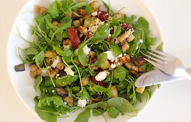 Fresh salad with fried eggplant, feta and basil oil
