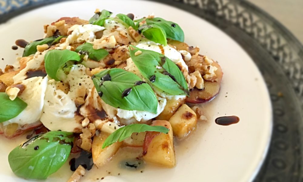 A summery twist on the classic caprese with grilled peach and a sweet balsamic dressing