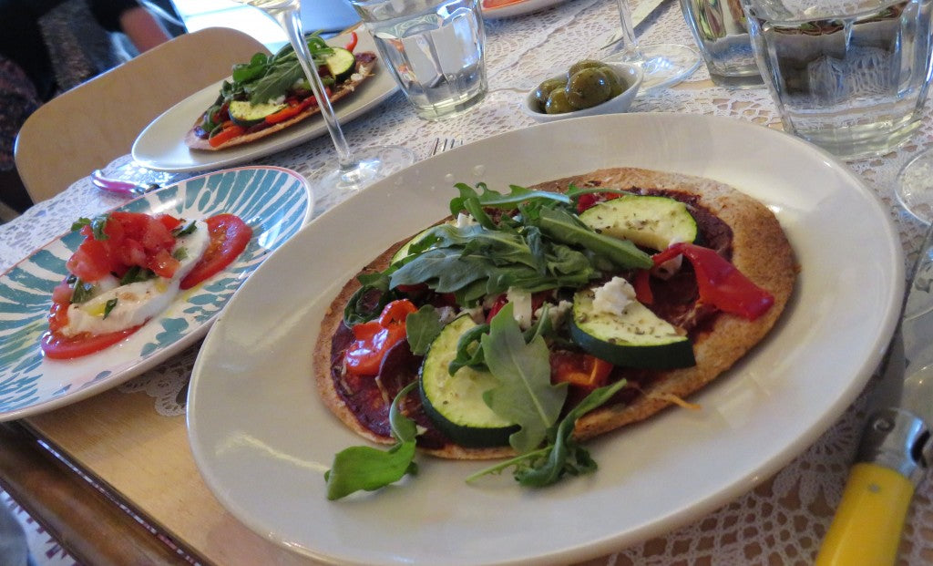 Crispy mini-pizzas made from tortillas with fresh vegetables and feta