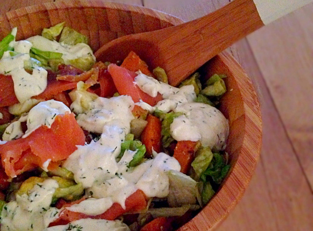 A colorful meal salad with a creamy dressing
