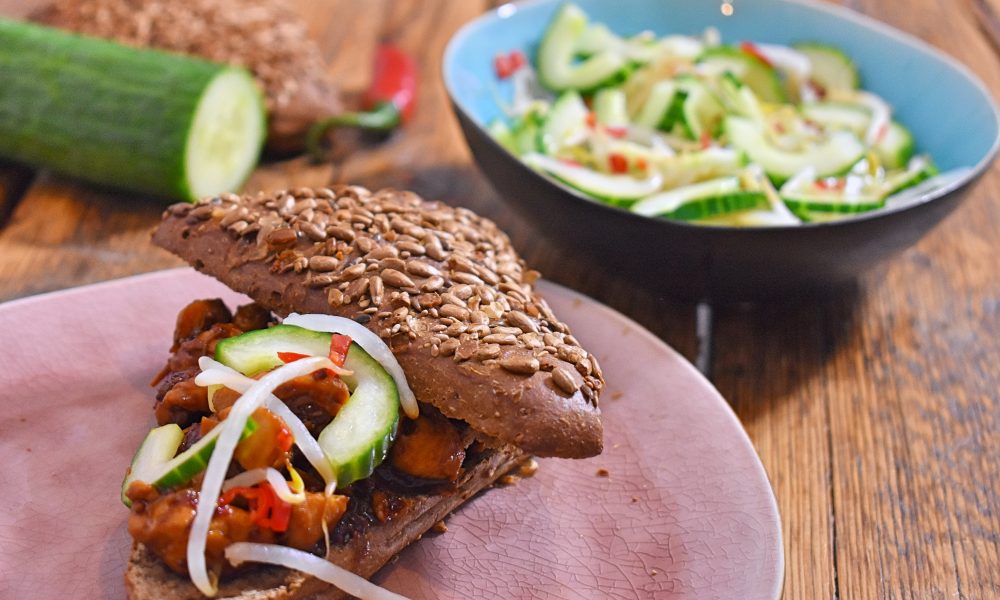 Pulled chicken with a spicy sauce and fresh pickled pepper and vinegar vegetables
