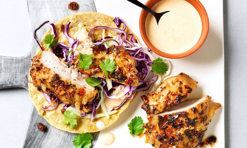 Spicy marinated chicken in crispy tortillas with homemade coleslaw