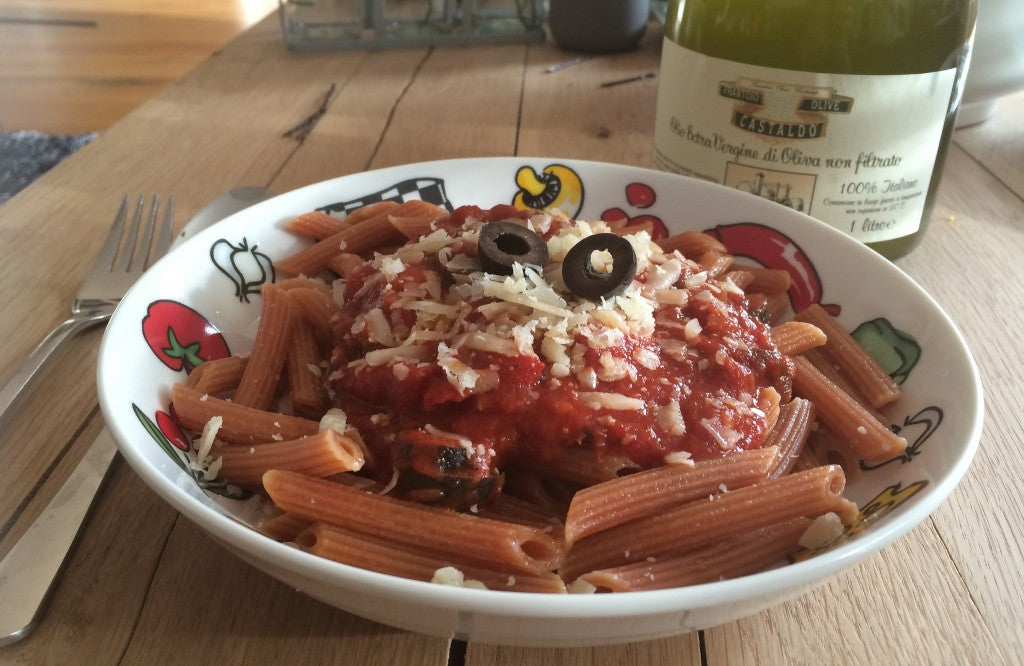A flavorful Italian pasta dish with a spicy sauce, anchovies and black olives