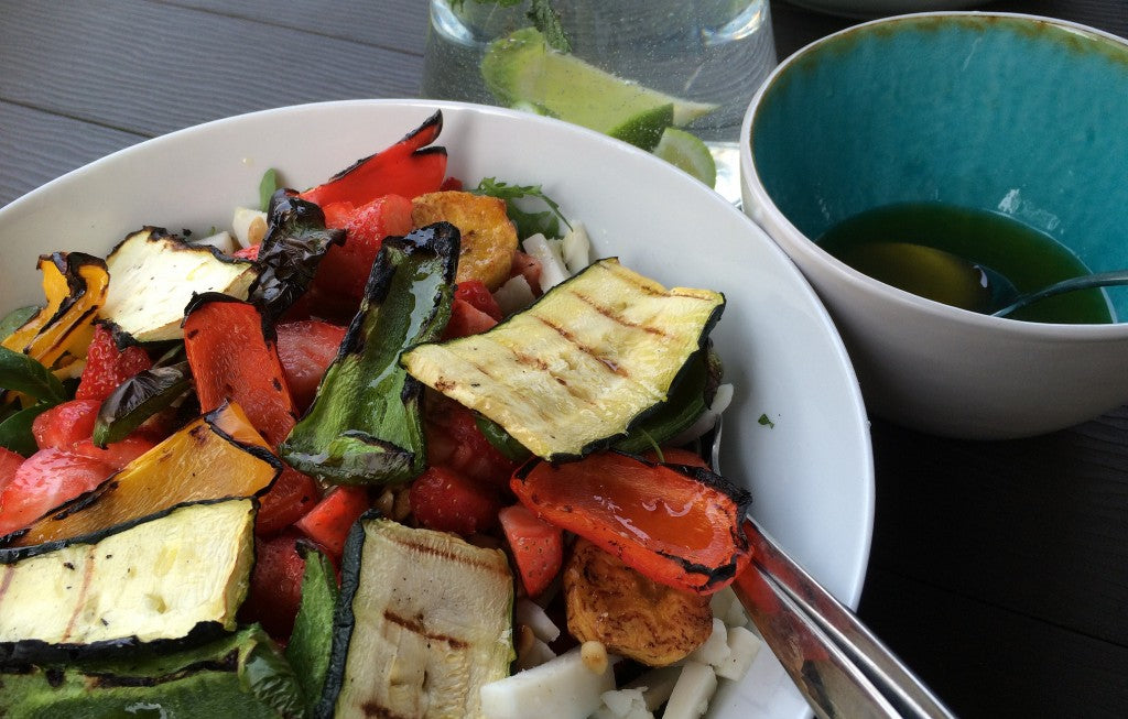 A fresh summer salad with grilled vegetables, goat cheese and a spicy ginger dressing